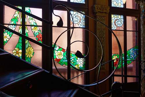 stained glass green and multicolored floral mosaic art near stairs animal